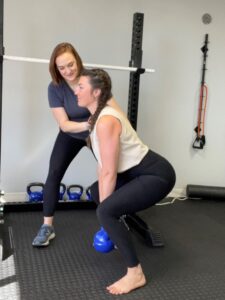 A picture of Dr. Olivia and a patient working on exercise form