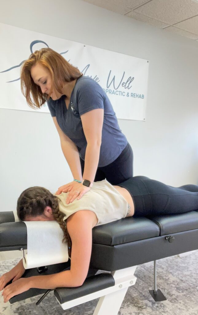 A picture of Dr. Olivia adjusting a patient.