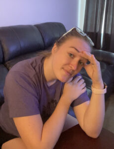 A picture of someone with a headache grabbing their head.