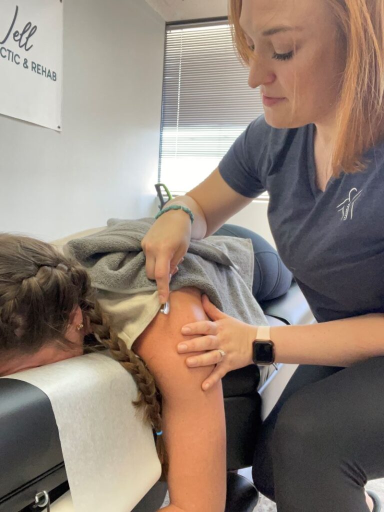 A picture of a patient receiving Graston technique on their shoulder.